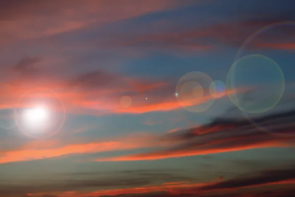 Lens flare on beautiful sunset sky — Stock Photo, Image
