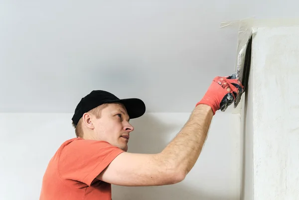 De werknemer legt het stucwerk op de muur — Stockfoto