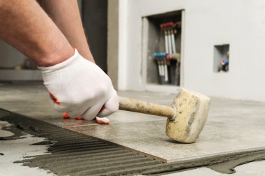 Seramik karo döşeme. Seramik tam bağ için knocking işçi.