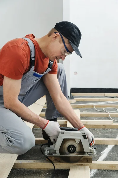 Робітник вирізає дерев'яні дошки для підлоги . — стокове фото