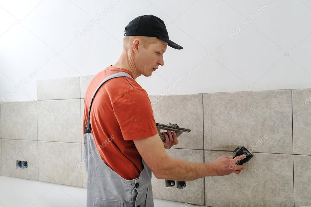 Fill the tile joints with grout. — Stock Photo © Yunava1 107259552