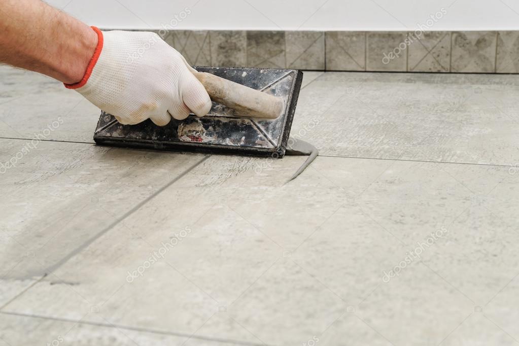 Grouting ceramic tiles. Stock Photo by ©Yunava1 120192384