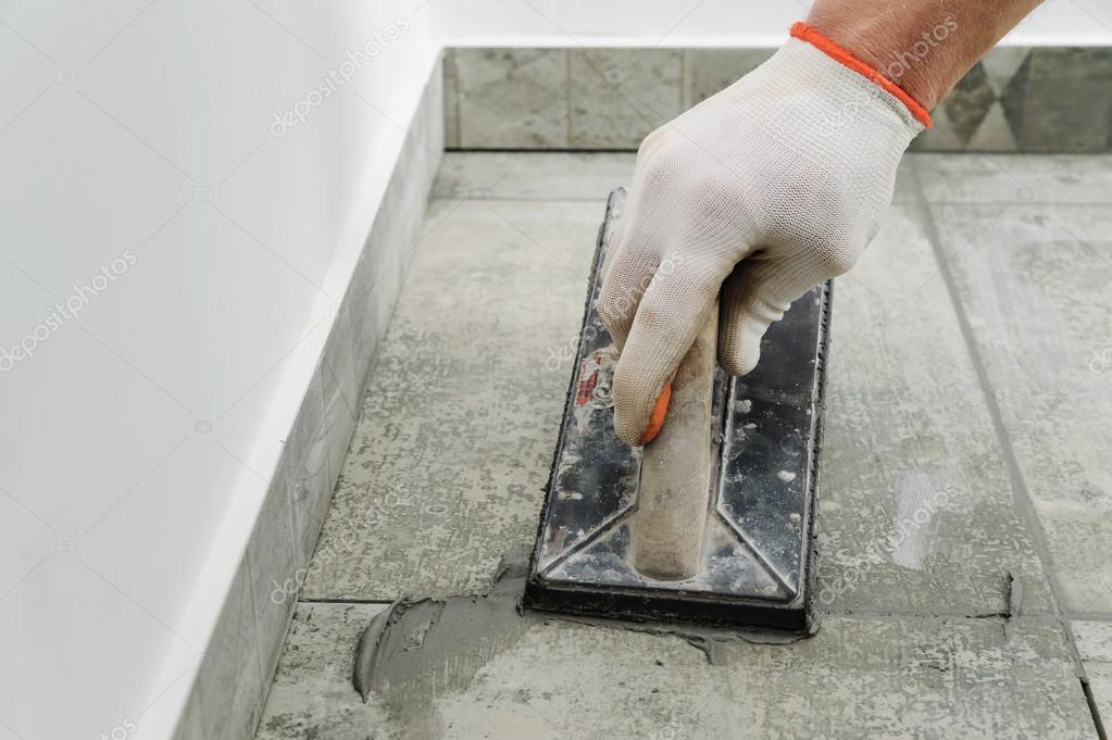 Grouting ceramic tiles. Stock Photo by ©Yunava1 121460000