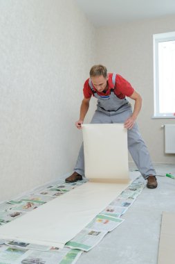 Worker pasting wallpapers. clipart