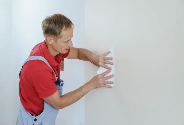 Worker pasting wallpapers. — Stock Photo, Image