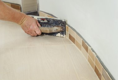 Fill the tile joints with grout clipart
