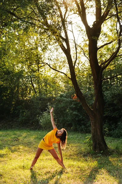 Young beautiful woman doing yoga exercise — Stock Photo, Image