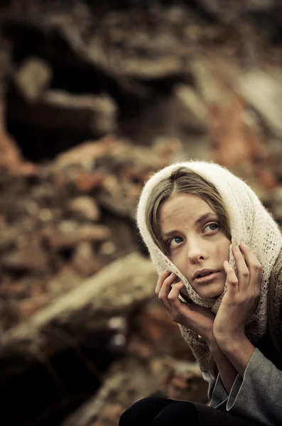 Young girl dressed in the poor sweater and scarf — Stock Photo, Image