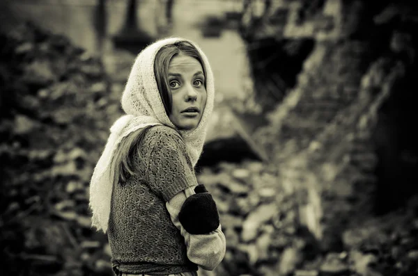 Young girl dressed in the poor sweater and scarf — Stock Photo, Image