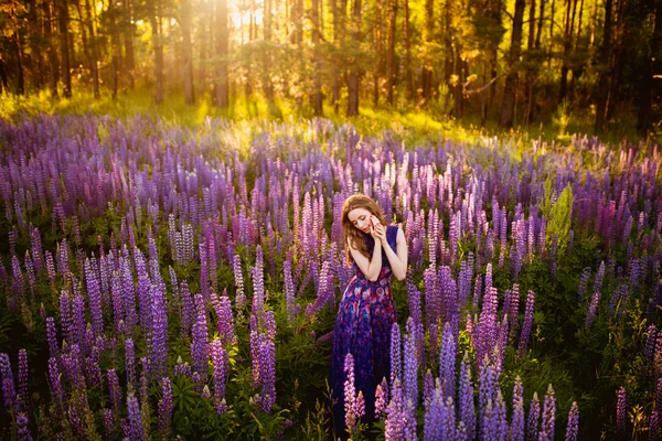 Dziewczyna w polu fioletowe kwiaty — Zdjęcie stockowe
