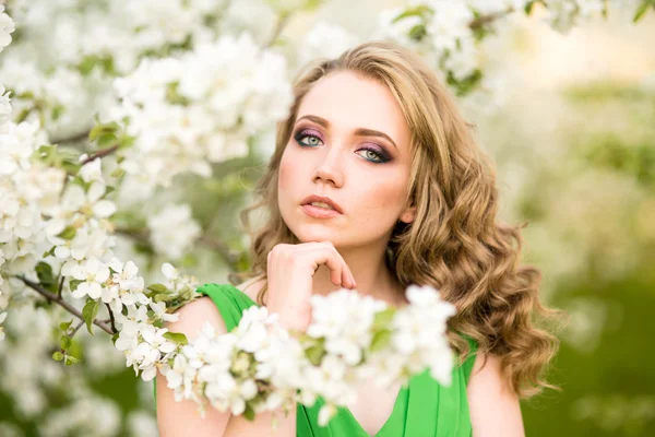 Mulher jovem feliz bonita no jardim florescente de primavera — Fotografia de Stock