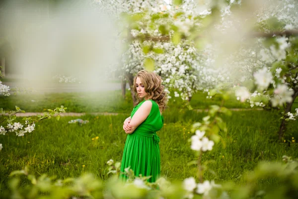 在盛开的花园的苹果树上时尚漂亮的金发女人 — 图库照片