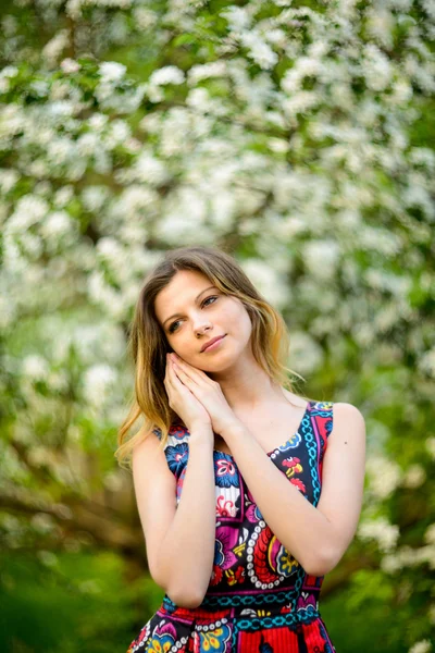 Beautiful woman in blooming garden — Stock Photo, Image