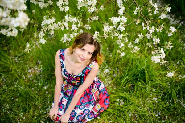 Beautiful woman in blooming garden — Stock Photo, Image