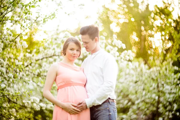 Couple in love under blooming branches spring day. — Stock Photo, Image