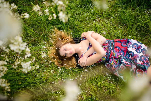 Beautiful woman in blooming garden — Stock Photo, Image