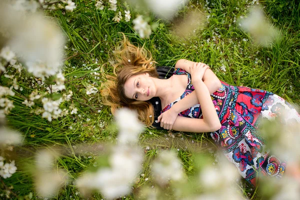 Beautiful woman in blooming garden — Stock Photo, Image