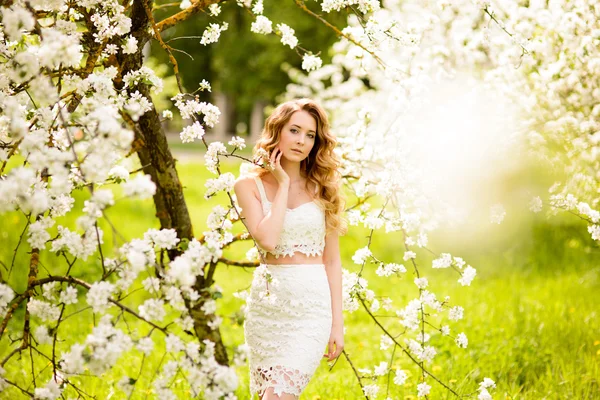 Весна красива дівчина, блондинка, стоїть в квітучому саду Apple  . — стокове фото