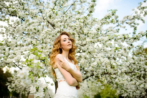 Krásná žena v rozkvetlé zahradě — Stock fotografie