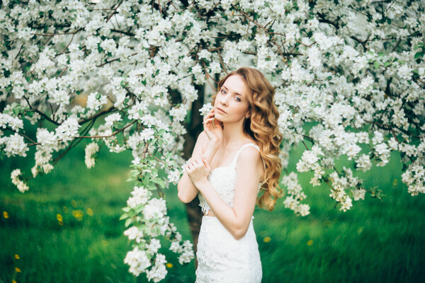 Beautiful woman in a blooming Apple orchard
