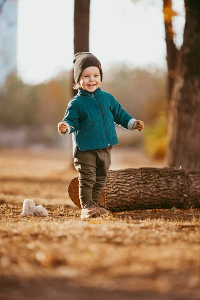 Joyful child runs. A boy dressed in a green jacket and brown pants. — Stock Photo, Image