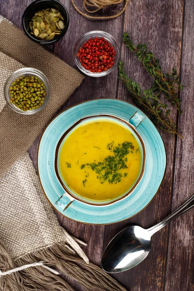 Carrot soup on a wooden table — Stock Photo, Image