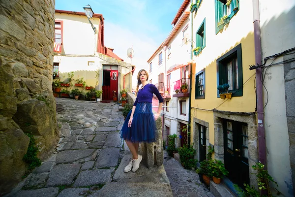 Young girl stands on the street among in Porto — Stock Photo, Image