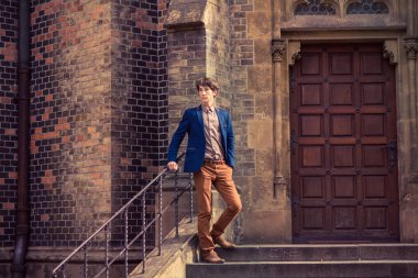 adam bej pantolon ve mavi bir ceket