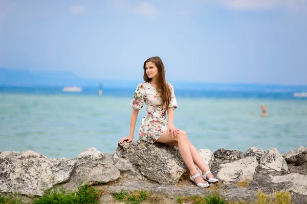 Mulher bonita sentada na rocha sobre o mar — Fotografia de Stock