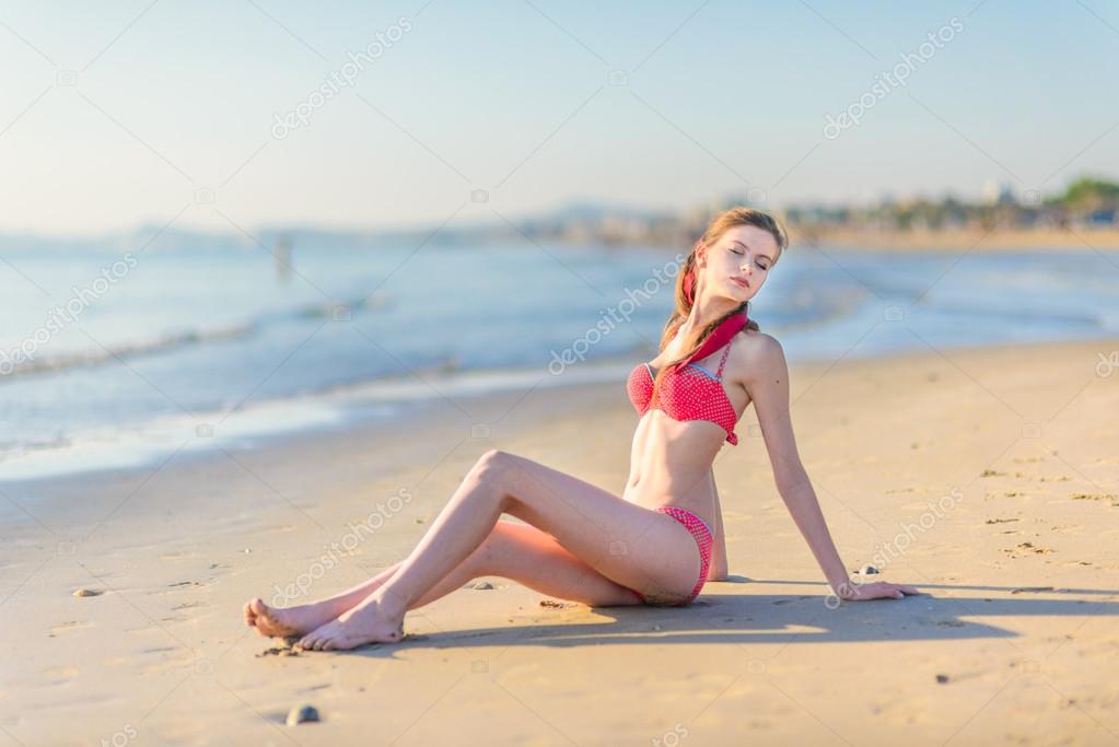 Beautiful young woman bikini pinup beach Stock Photo by ©zakharovaleksey 96539258