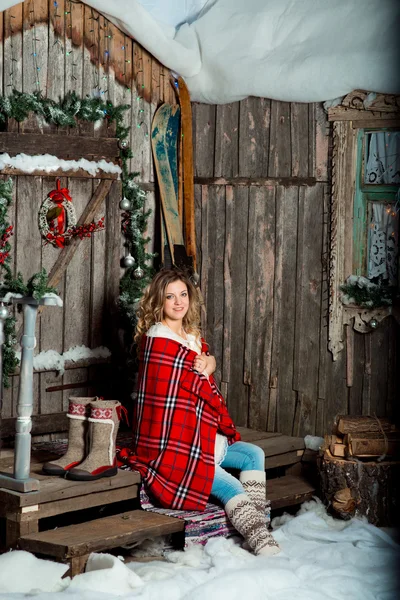 girl about Christmas porch covered with a heated blanket