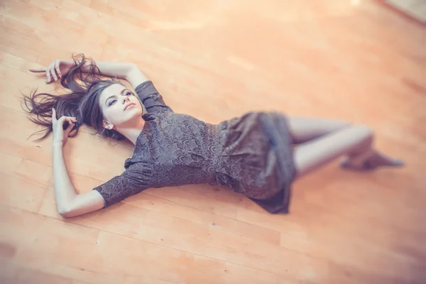 Seductive woman lying on the floor Royalty Free Stock Images