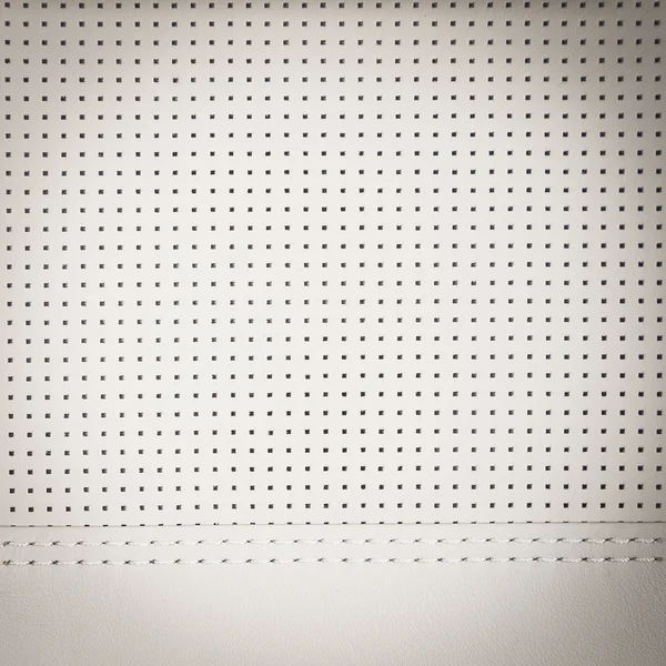 White perforated natural leather background — Stockfoto