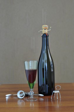 Bir bardak şarap şişesiyle.