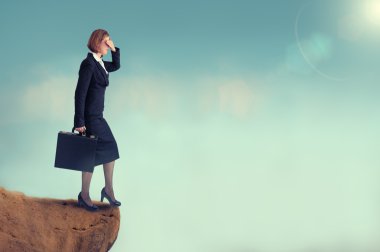 Businesswoman on the edge of a cliff clipart