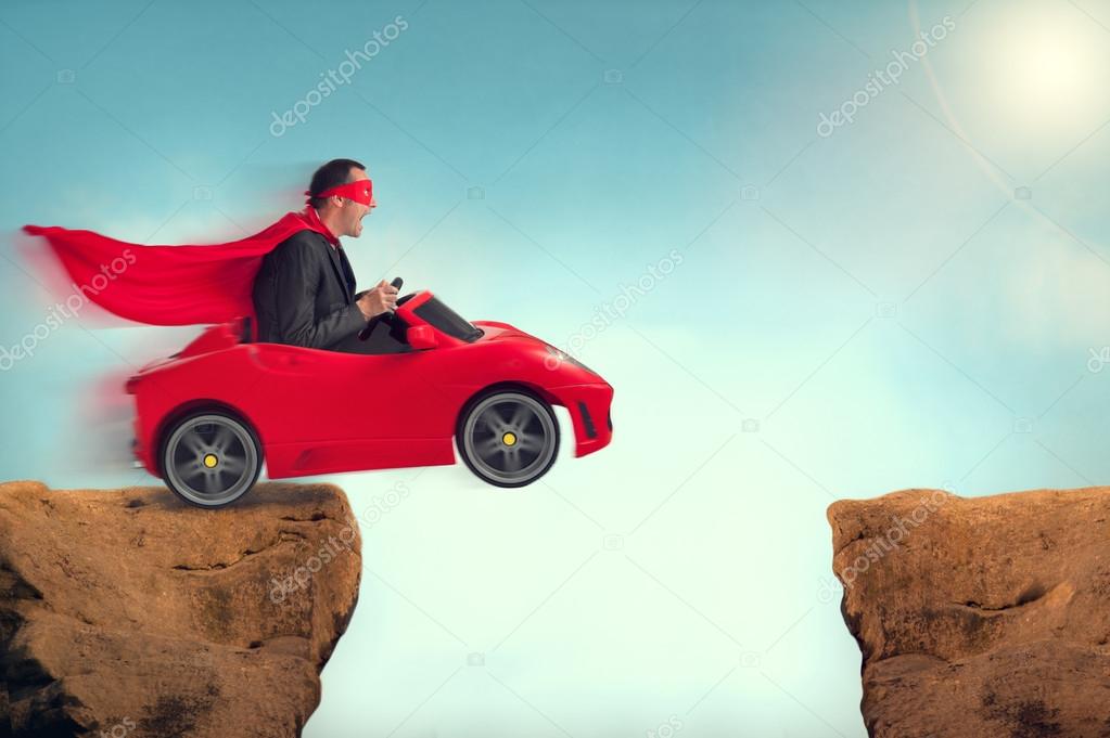 Man in a car jumping a ravine