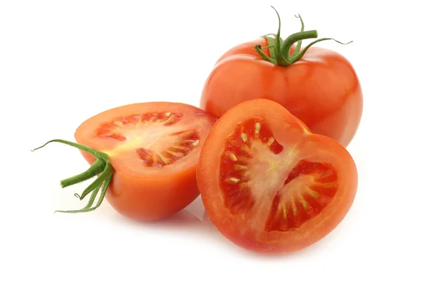 Fresh tomato and a cut one — Stock Photo, Image