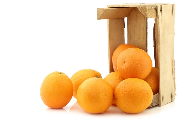 Fresh oranges in a wooden crate — Stock Photo, Image