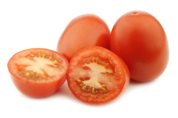 Fresh and colorful italian roma tomatoes and a cut one — Stock Photo, Image