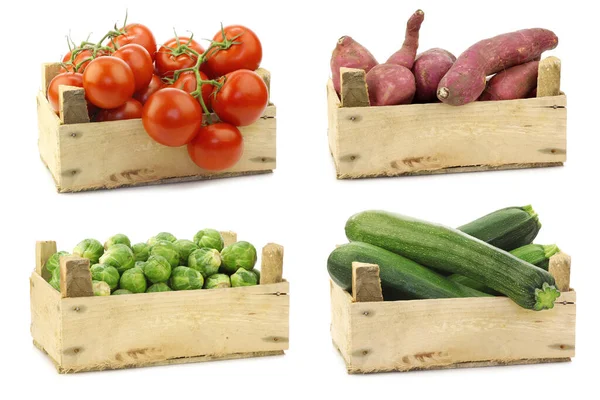 Fresh cooking vegetables in a wooden crate on a white background