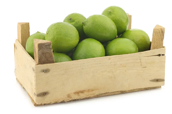 Lime fruits in a wooden crate — Stock Photo, Image