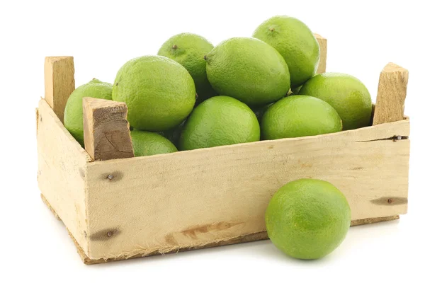 Lime fruits in a wooden crate — Stock Photo, Image