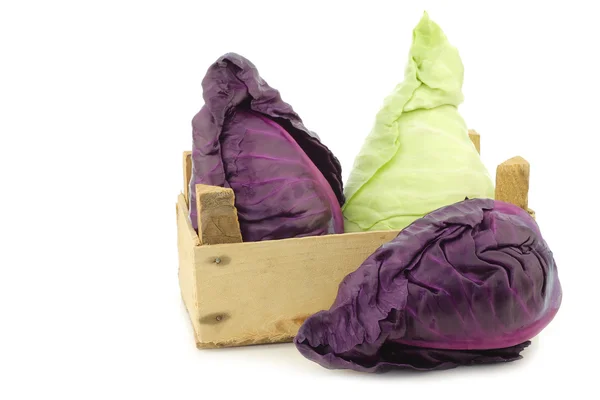 Red and green pointed cabbage in a wooden crate — Stock Photo, Image