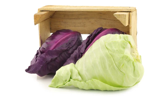 Red and green pointed cabbage in a wooden crate — Stock Photo, Image