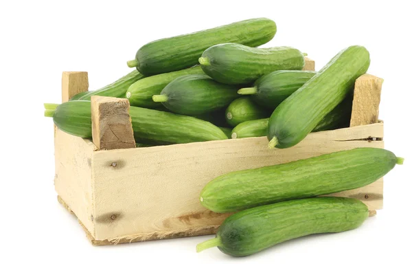 Fresh green snack cucumbers in a wooden box — Stock Photo, Image