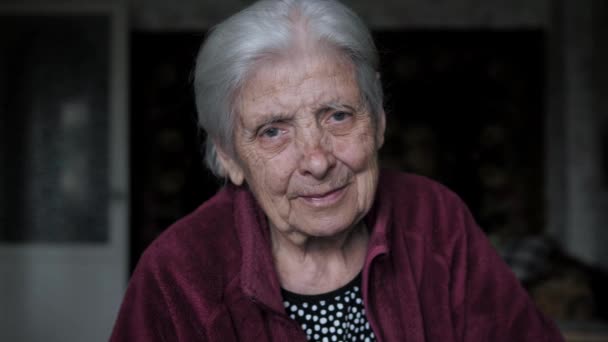 Portrait Of Old Woman With Tremor Nervous Tic Looking At Camera Sitting At Home — Stock Video