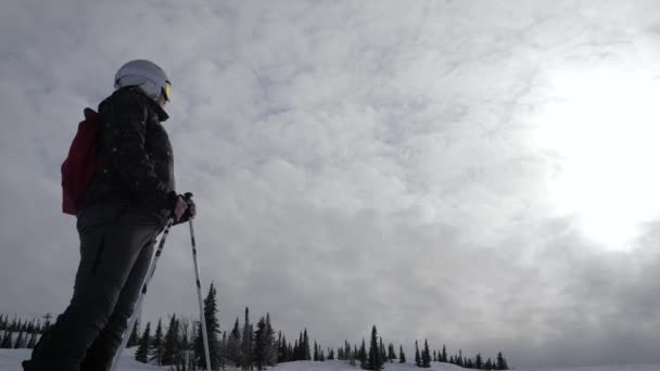 Esquiador de pie en la ladera de la montaña disfrutando de la libertad y la relajación de fondo de la puesta del sol — Vídeo de stock