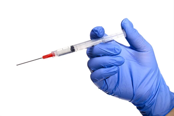 Hand in a blue glove holding syringe isolated on white — Stock Photo, Image