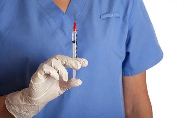 Hand in a white glove holding syringe, shallow focus — Stock Photo, Image