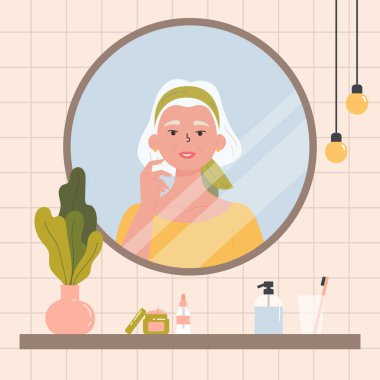 Yaşlı bir kadın aynada kendine bakıyor..